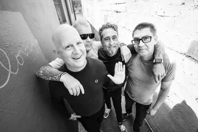 Good Riddance band members embracing each other